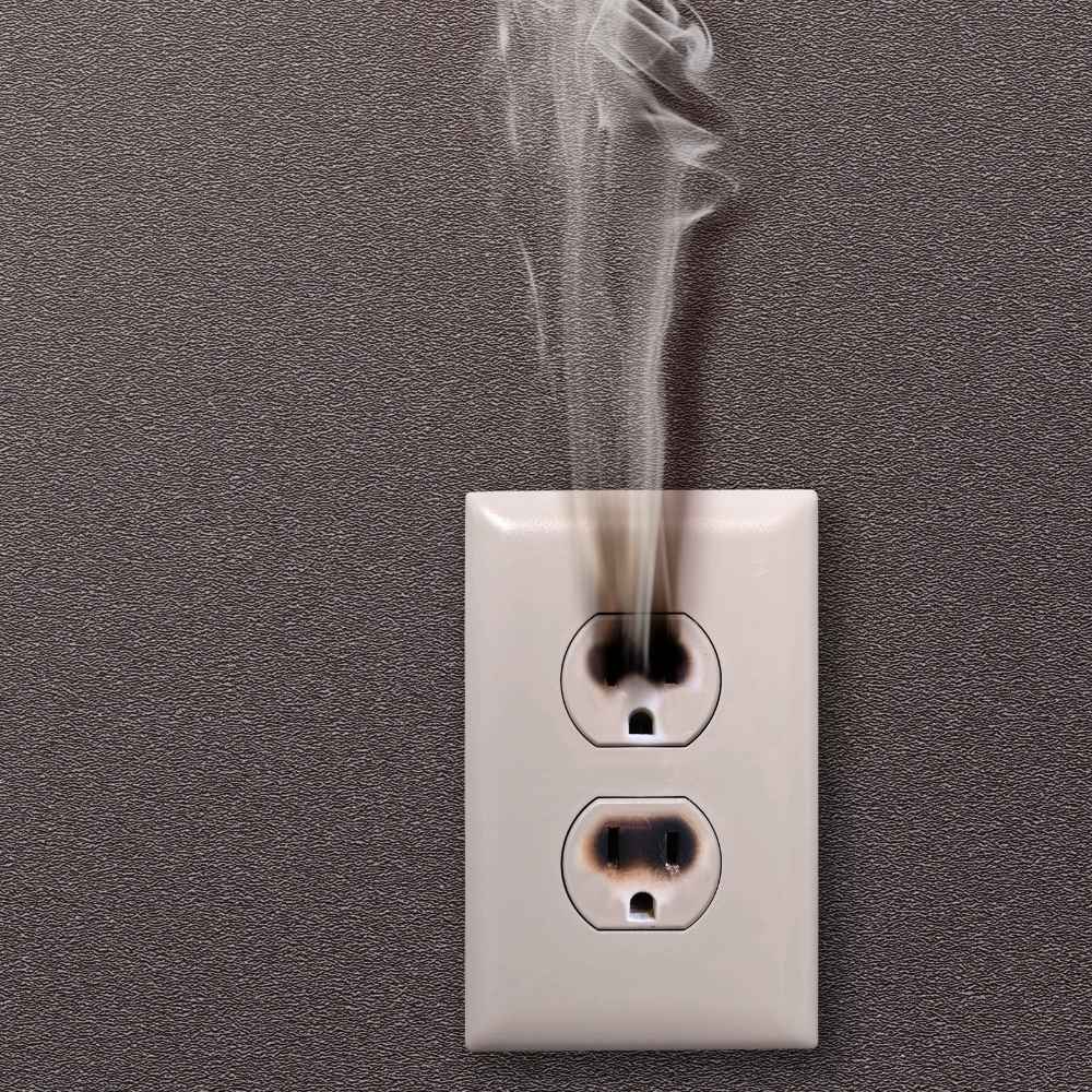 burning-outlet A burnt wall outlet with smoke escaping.